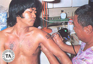 Johnny Two Thumbs tattooing with one of his unusual machines.