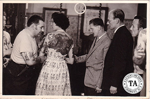 Pam Nash posing with members of the Bristol Tattoo Club, circa 1950s.